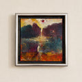 A square framed abstract painting with a textured impasto style, featuring a dark landscape with a bright sun-like circle near the top center. The painting is housed in a silver-toned frame and mounted on a light beige textured wall.